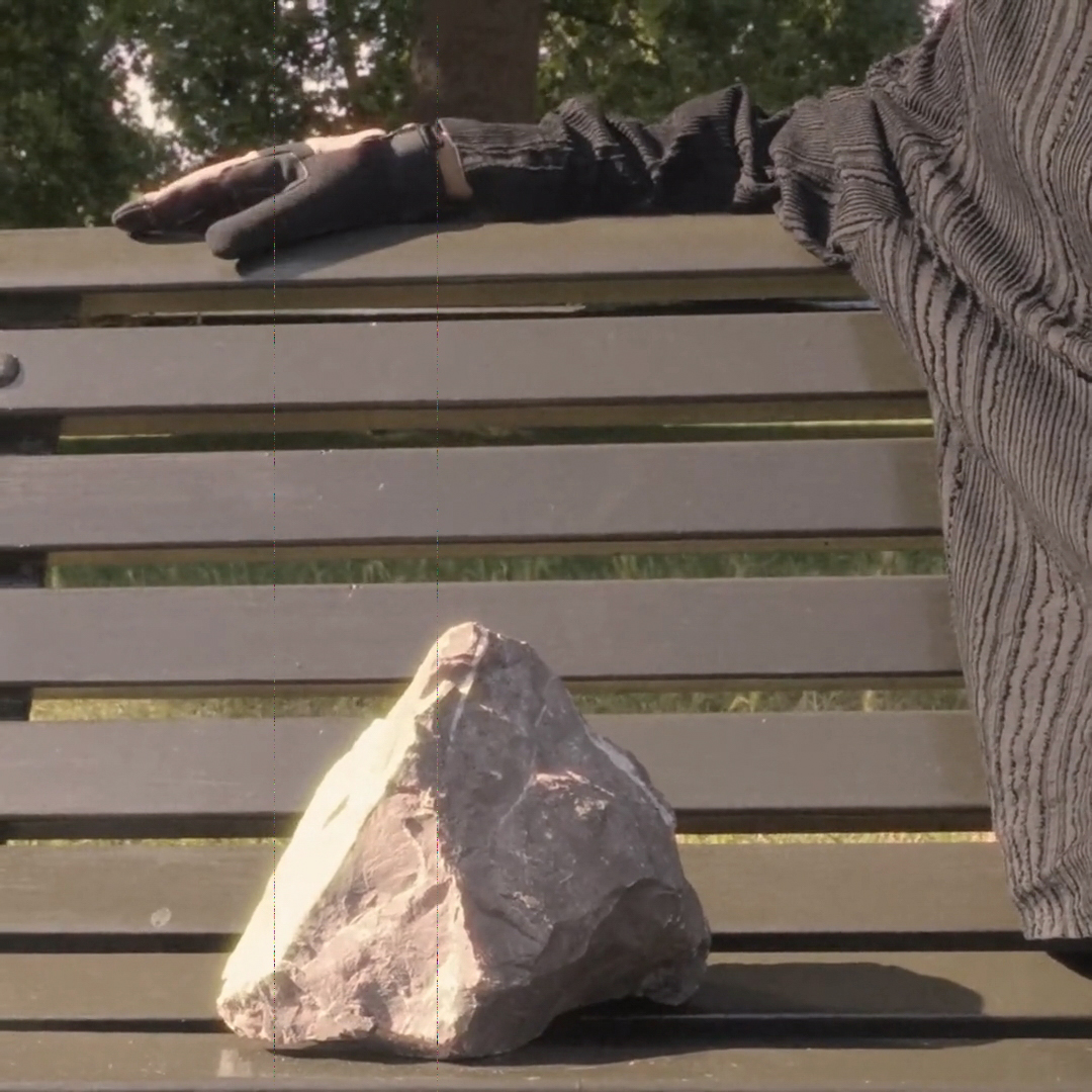 A stone resting on a park bench