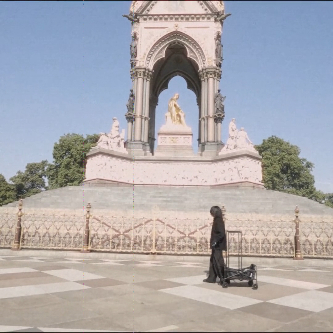 A person moving the stone past a memorial