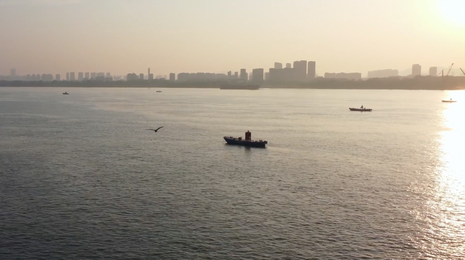 Boats crossing the Yangtze River at sunset
