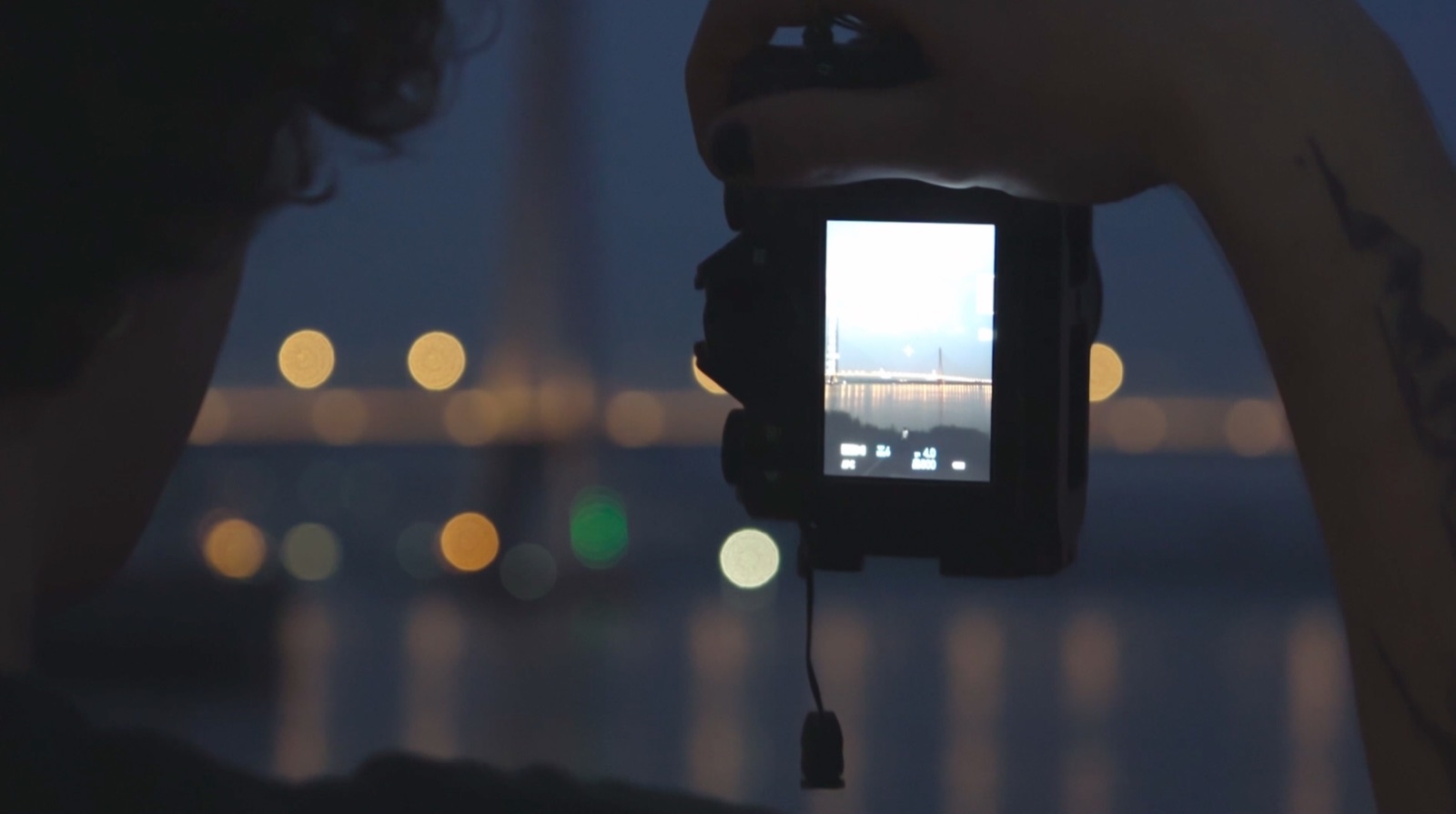 A camera framing the river at night
