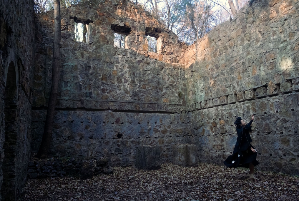A figure moving inside the stone ruins