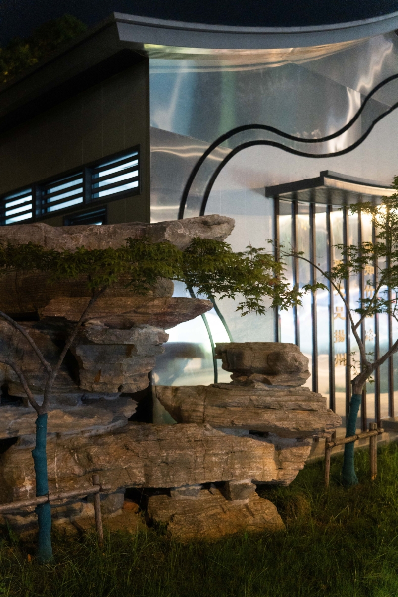 Modern architecture reflected behind garden rocks