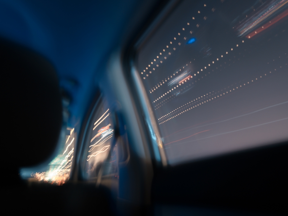 Blue light and reflections seen through a train window