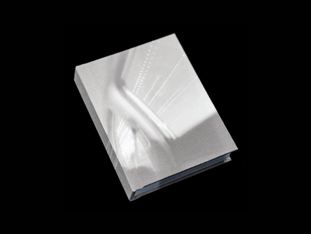 Artist book opened upright on a black background