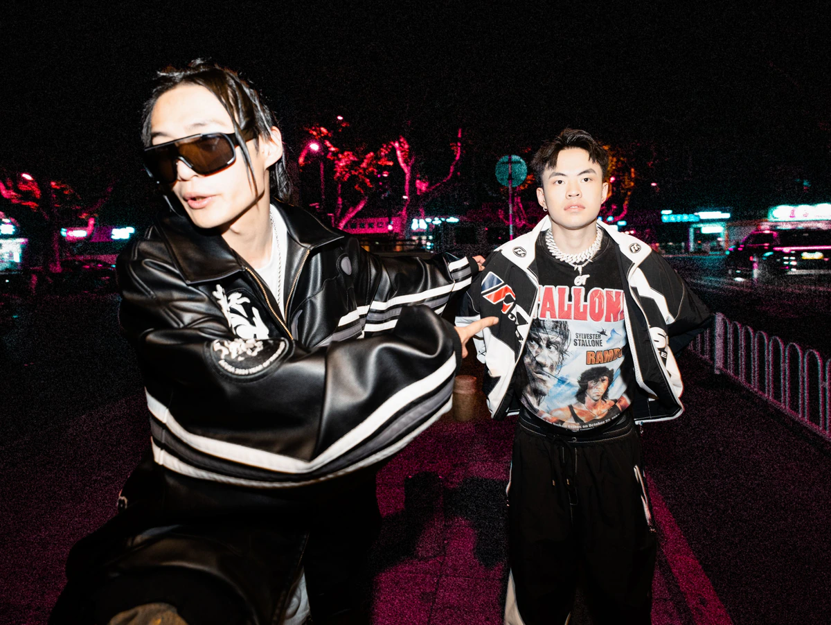 Black The Devil and GT photographed on a neon-lit street at night