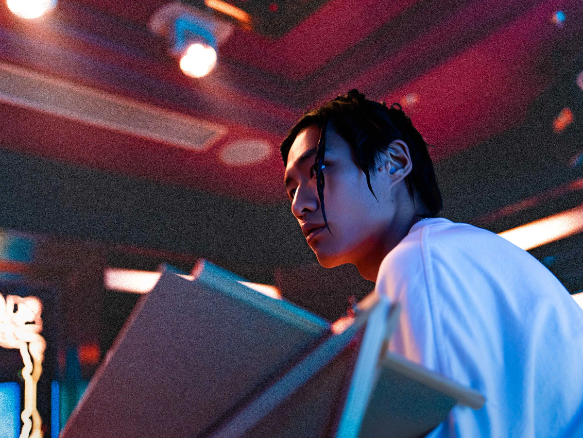 Portrait of a performer under saturated club lighting