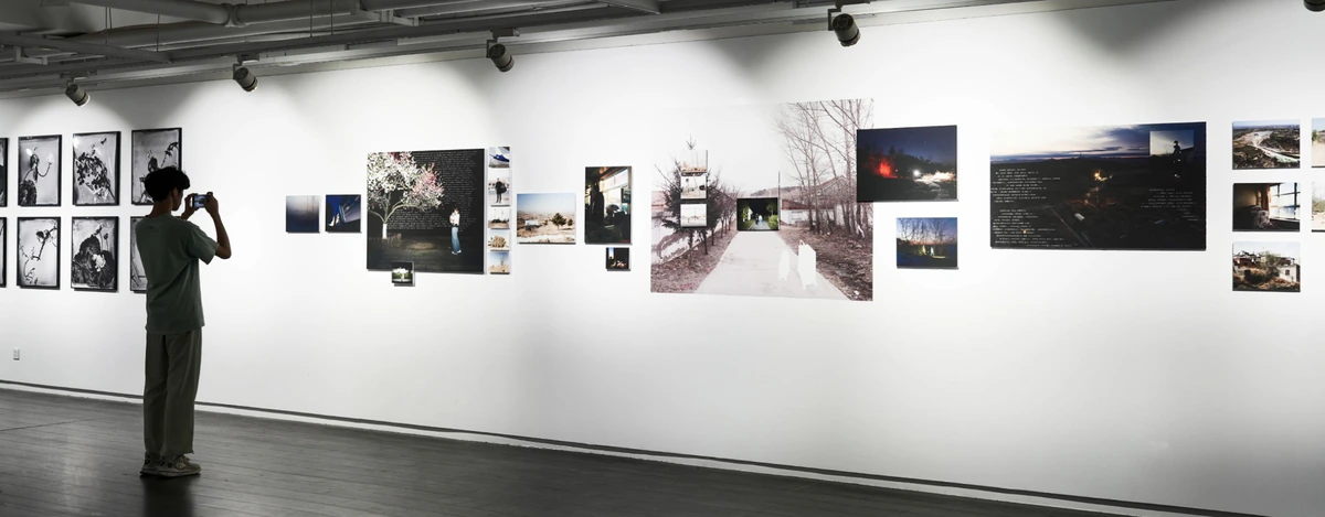 Visitors viewing Where Roads Begin to Split in an exhibition