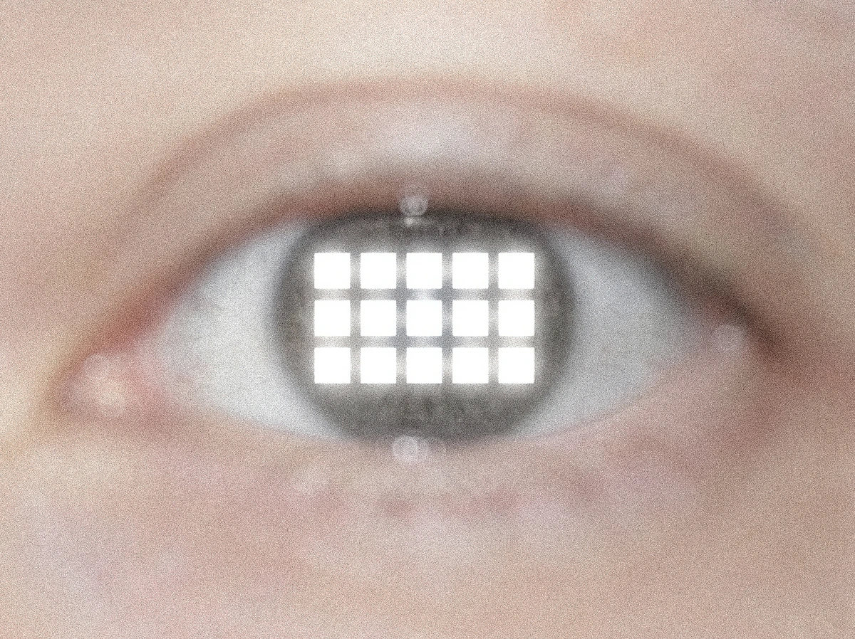 Eye reflecting a grid of fifteen illuminated squares