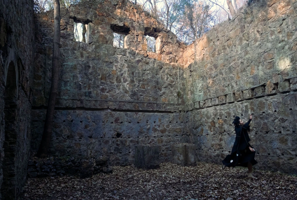 A figure moving inside the stone ruins