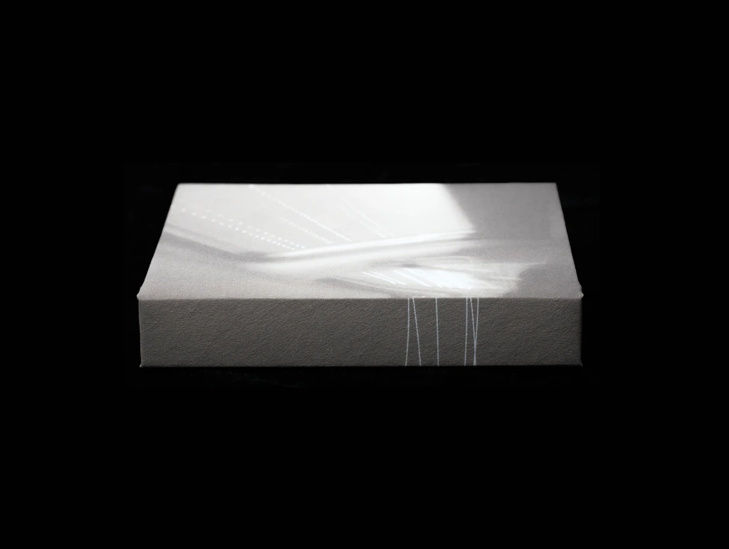 Open artist book with archival photographs